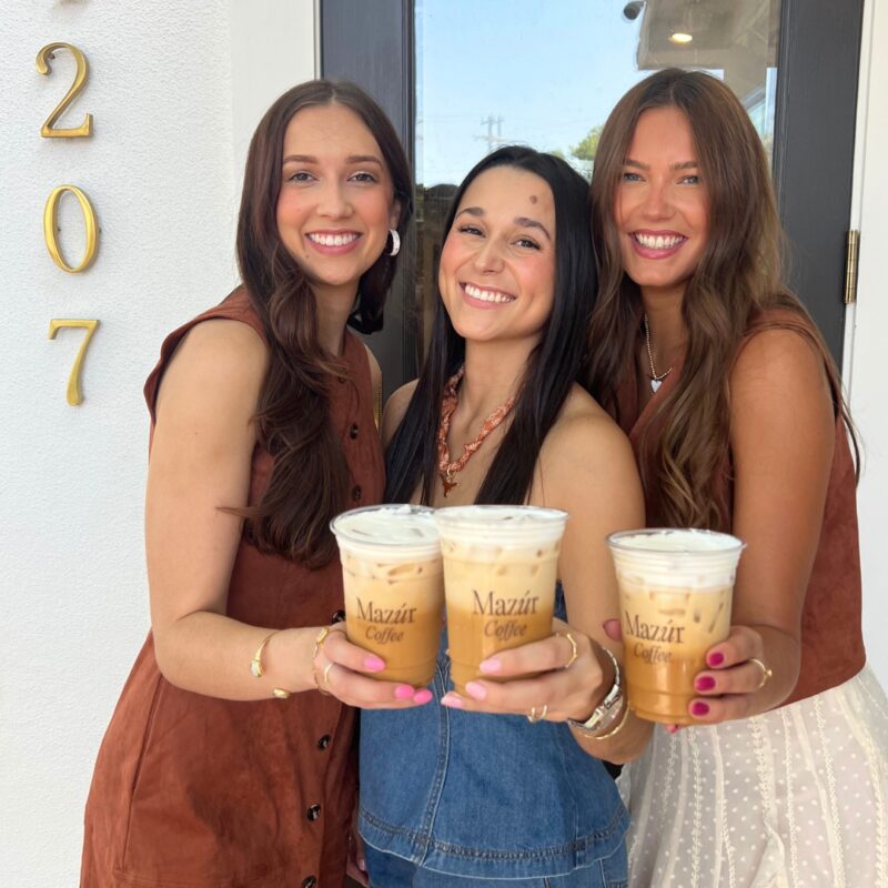 3 women holding up coffee showcasing mazur boutique for social media marketing