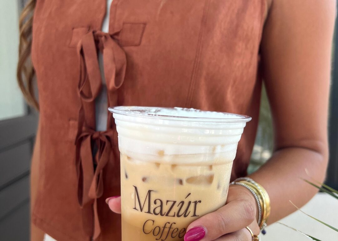 coffee and a burnt orange velvet suede vest showcasing mazur boutique for social media marketing
