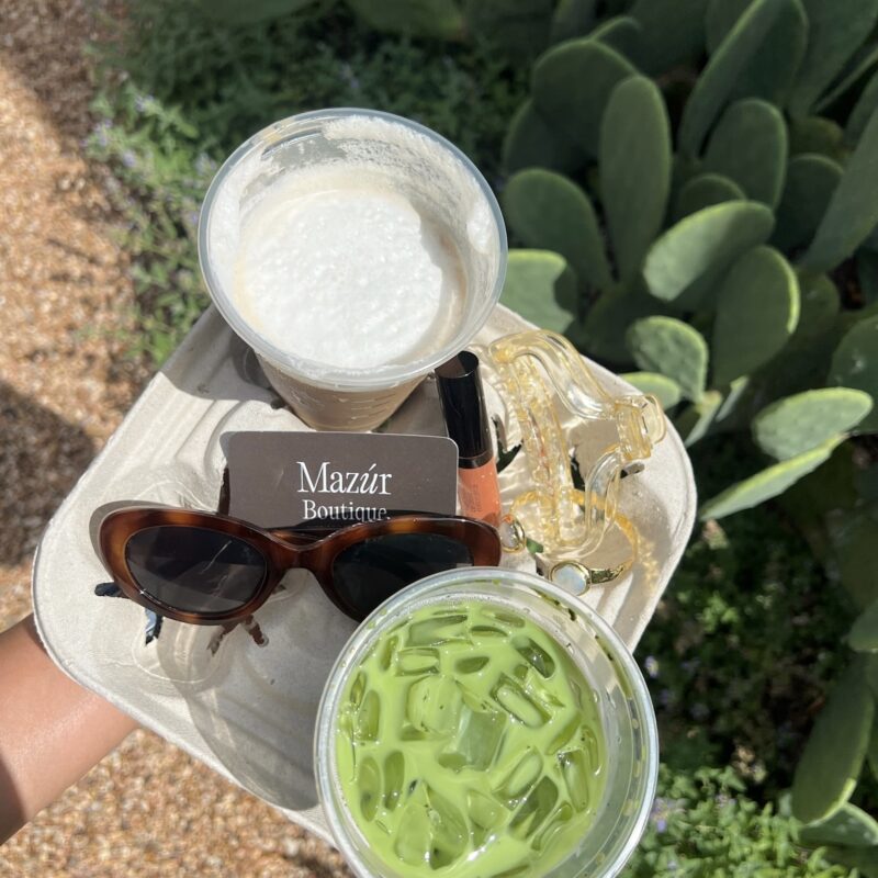 drink carrier holding a matcha and a iced coffee with sunglasses